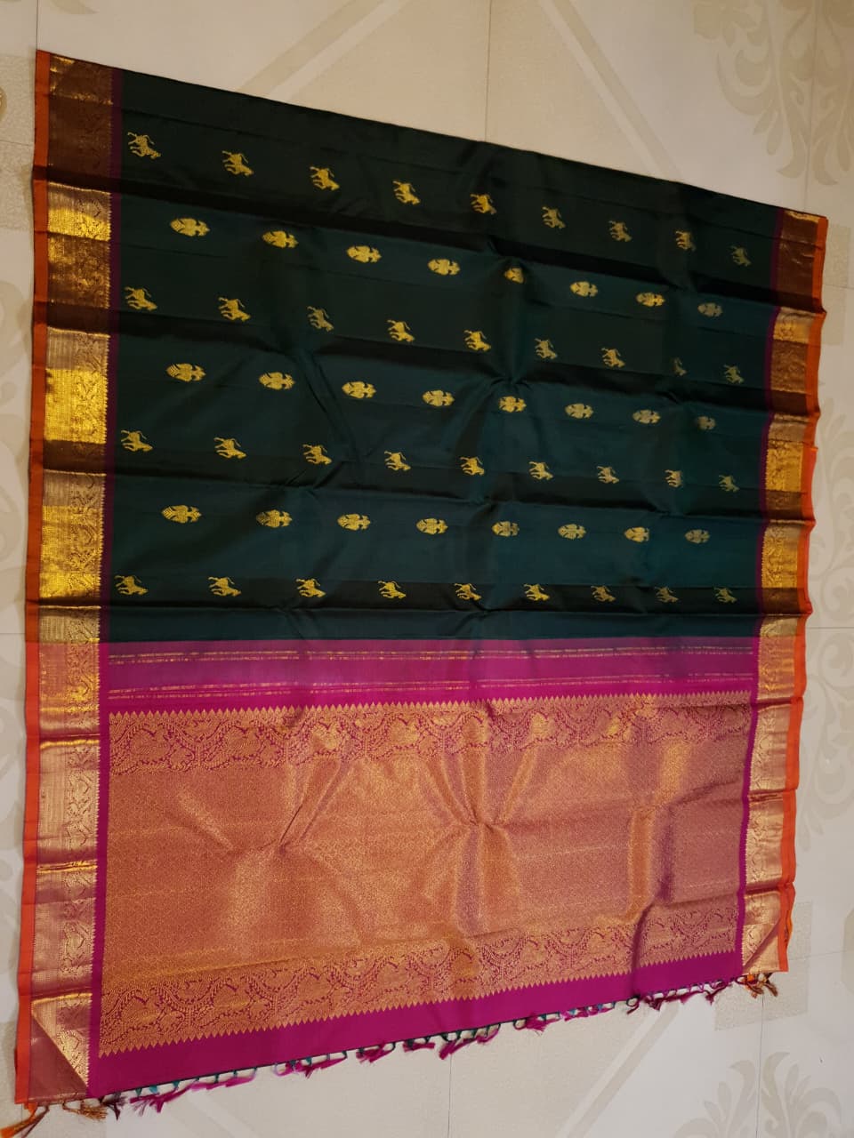 Bottle Green Kanjivaram Silk Saree with  Pink Zari Border.